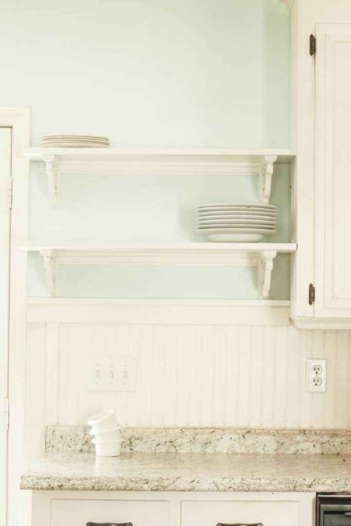 open kitchen shelves with white plates