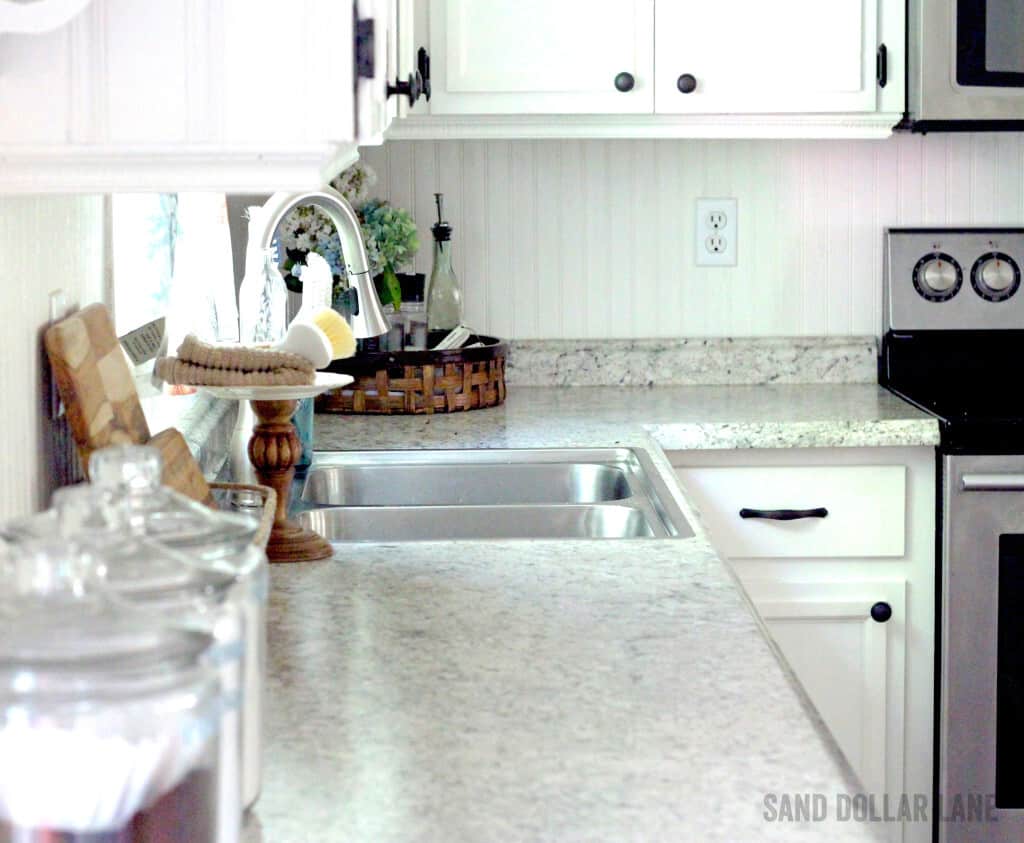 Bright white cabinets with beadboard backsplash