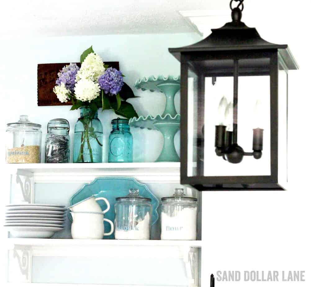 Latern style lighting in coastal farmhouse kitchen