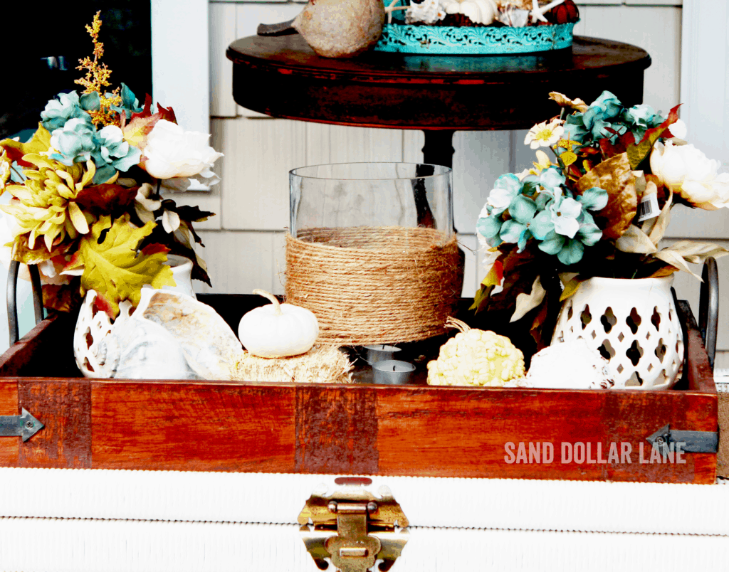 wooden tray with seashells and mini pumpknis