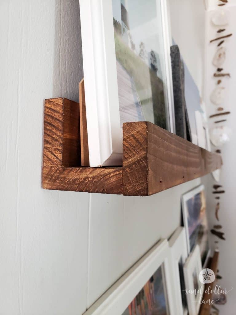 wooden photo ledge in coastal mudroom