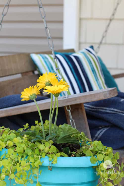 bright pillow on porch swing