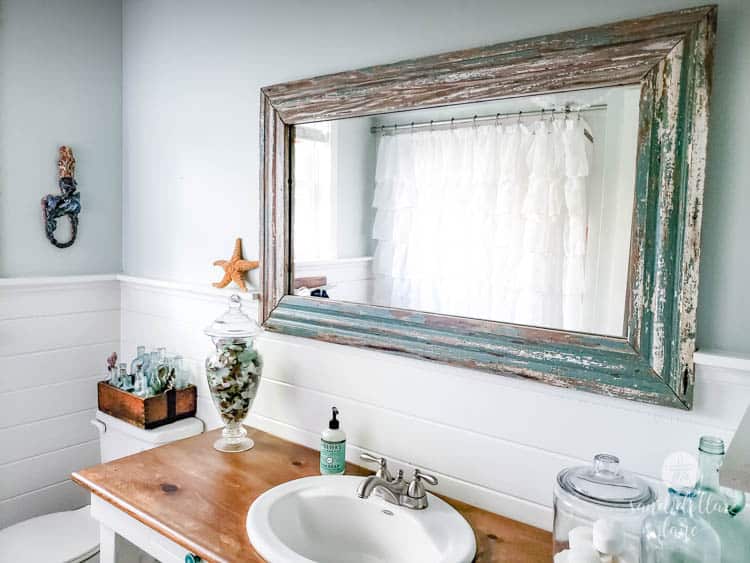 vintage mirror in coastal bathroom