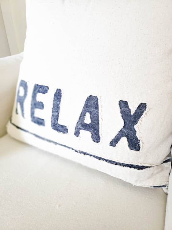 white pillow with word relax in blue