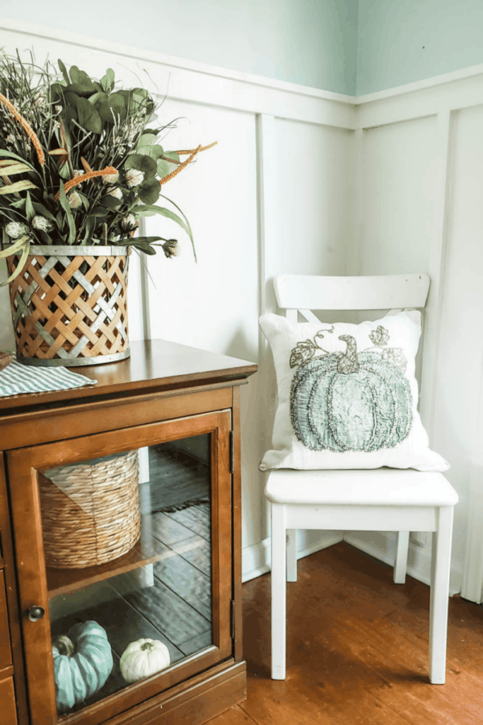 white chair with pumpkin pillow