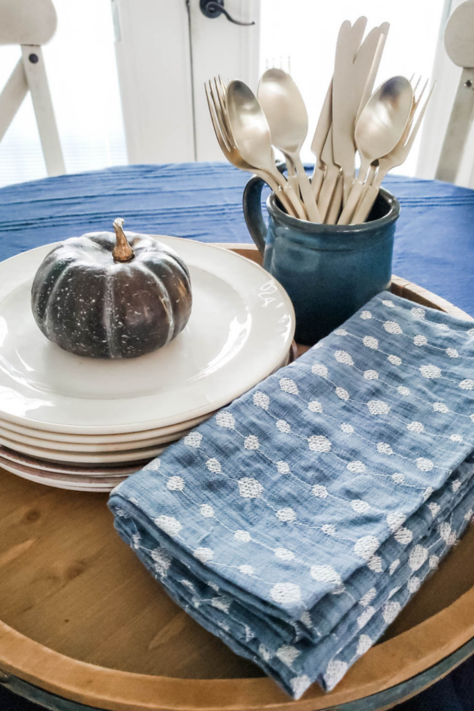 blue napkins and white plates on dining table