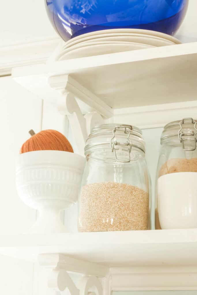 pumpkin on white kitchen shelves