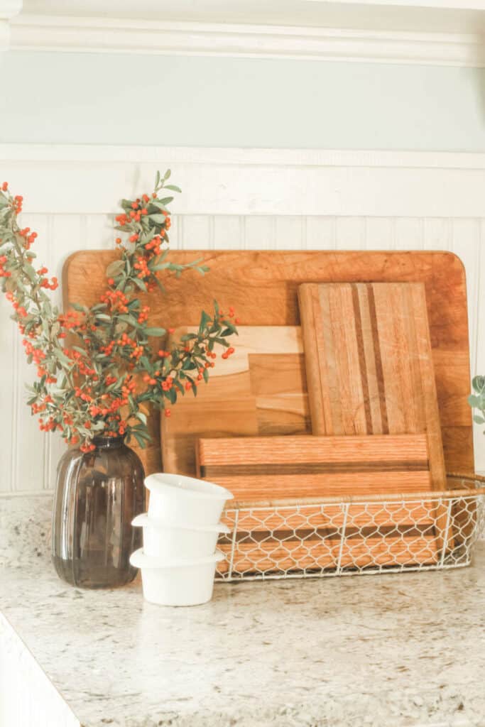 wooden cutting boards in white wire basket