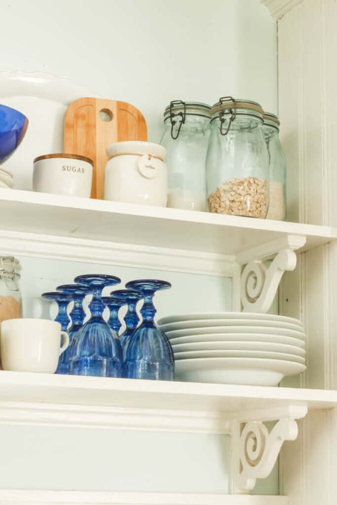 glasses and canisters on open kitchen shelving