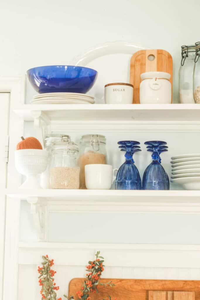 blue and white accessories on open shelves