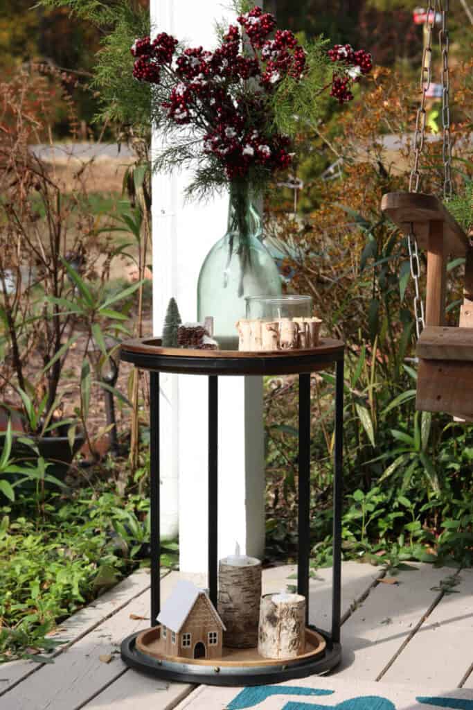 table on porch with natural Christmas decorations