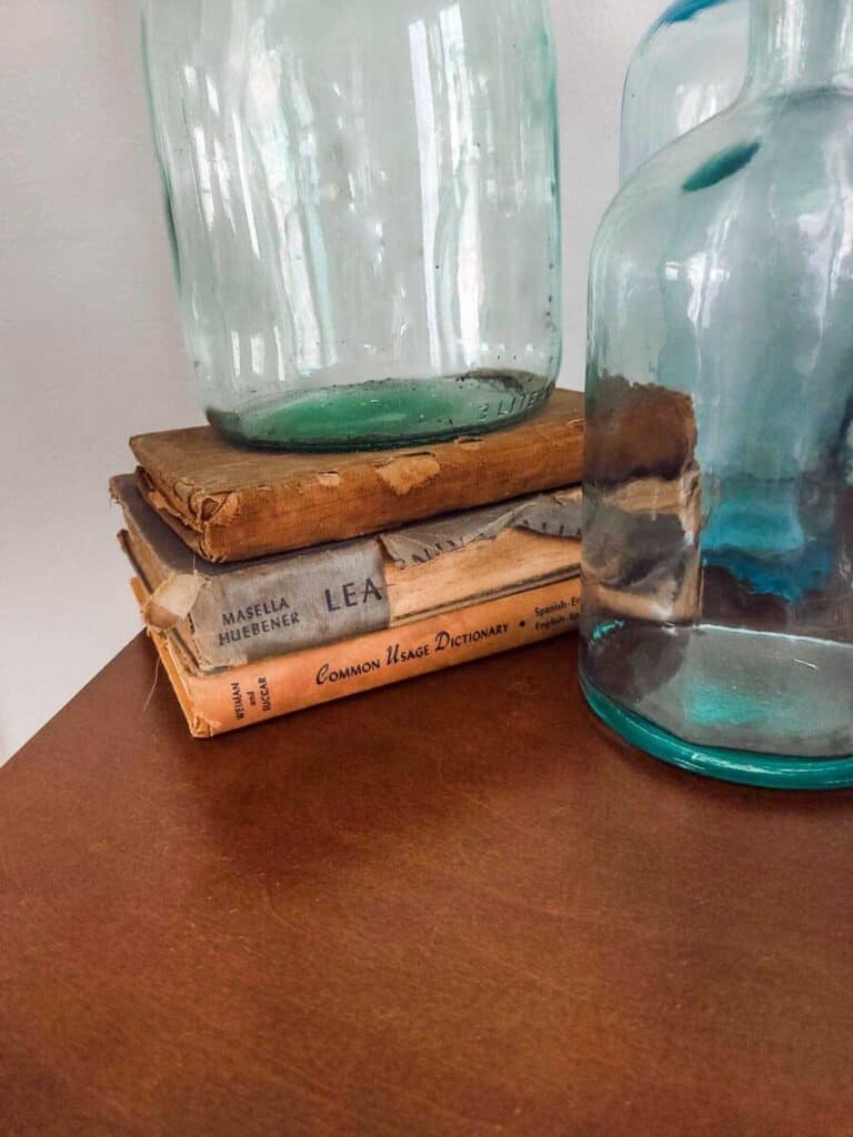 vintage books with glass jugs