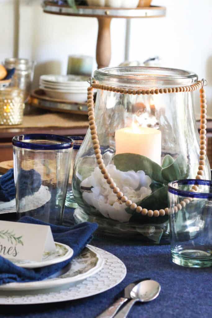 glass candle centerpiece on fall table